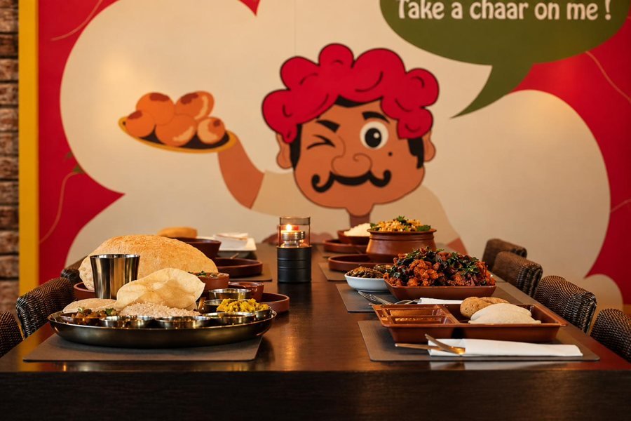 A set table in front of a street mural